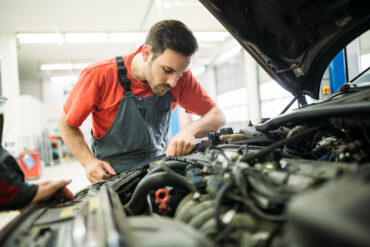 car mechanic fixing a transmission