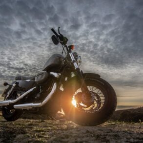 https://www.pexels.com/photo/low-angle-photo-of-black-harley-davidson-forty-eight-1200-motorcycle-parked-on-dirt-road-during-golden-hour-2611690/