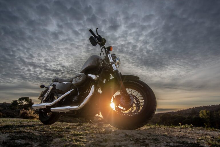 https://www.pexels.com/photo/low-angle-photo-of-black-harley-davidson-forty-eight-1200-motorcycle-parked-on-dirt-road-during-golden-hour-2611690/