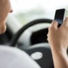 man using phone while driving