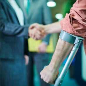 Injured man shaking hands with his personal injury lawyer