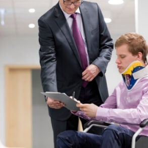 Injured man signing document
