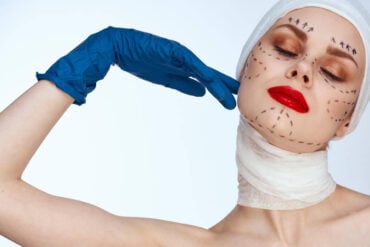 Midsection of woman with face paint against white background