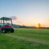 The golf course landscape with beautiful sky. Golf cart at the g