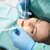 Woman receiving dental treatment in dentist office