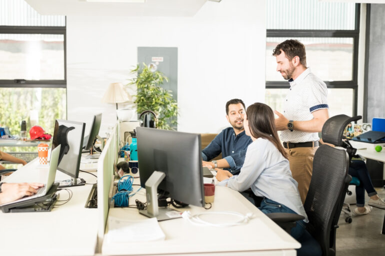 group of three business people discussing work
